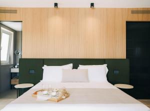 En eller flere senge i et værelse på Essenza Relais Contemporaneo