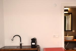 a bathroom with a sink and a mirror at Benjamin Otel Gumusluk in Gumusluk