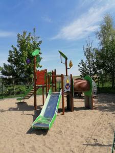 a playground with many different types of play equipment at Zagroda nad Hańczą in Błaskowizna