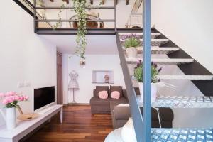 a living room with a staircase with potted plants at Romantic loft Porta Venezia MILAN in Milan