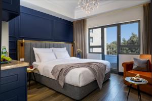 a bedroom with a large bed and a blue wall at The David Story Boutique in Jerusalem