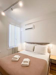 Postel nebo postele na pokoji v ubytování Voulis Attico Rooms & Apartments