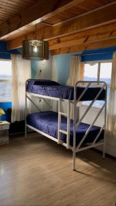 two bunk beds in a room with a ceiling at Berkana hostel Bariloche in San Carlos de Bariloche