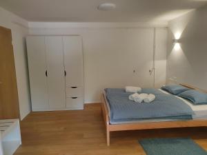 a bedroom with a bed with two towels on it at Apartmaji Pregelj in Koper