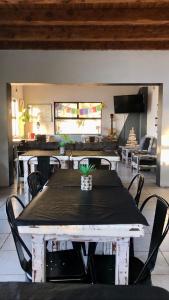 a dining room with a table and chairs with a plant on it at Berkana hostel Bariloche in San Carlos de Bariloche