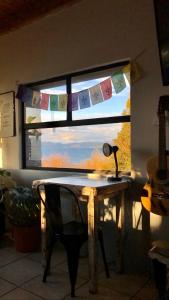 a window with a desk with a lamp in front of it at Berkana hostel Bariloche in San Carlos de Bariloche
