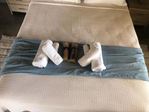 three pairs of socks laying on a bed at Thealassa in Kalliópi