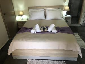 a bed with two towels and two stuffed animals on it at Thealassa in Kalliópi