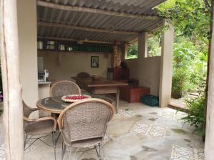 a patio with a table and chairs on a patio at Sitio Natividade in Delfim Moreira