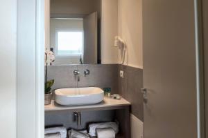 a bathroom with a sink and a mirror at Hotel Rex in Livorno