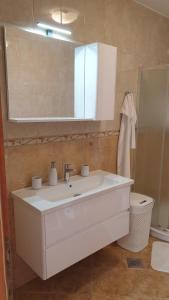 a bathroom with a white sink and a mirror at Ana in Kostrena +39 photos