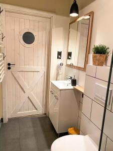 a bathroom with a white door and a sink at Apartamenty 41 in Poznań