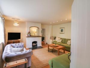 a living room with a couch and a fireplace at Stert Mill in Diptford