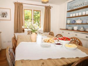 a dining room table with food on it at Stert Mill in Diptford