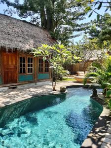 a small swimming pool in front of a house at Musa Bintang Villas and Bungalows Gili Air in Gili Air
