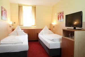 Postel nebo postele na pokoji v ubytování TOP Hotel Amberger
