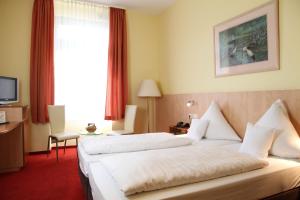 Postel nebo postele na pokoji v ubytování TOP Hotel Amberger