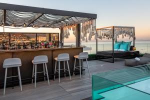 a bar on a deck with a view of the ocean at O' Two Hotel in Cape Town