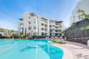 a swimming pool in front of a building at Ancor 0-1 POOL VIEW 2B in Palm-Mar