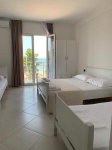 a bedroom with two beds and a view of the ocean at Sunny Breeze Shengjin in Shëngjin