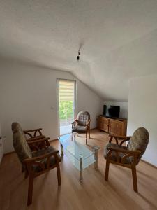 科尼茨S&R Lake View Hostel的客厅配有两把椅子和一张玻璃桌