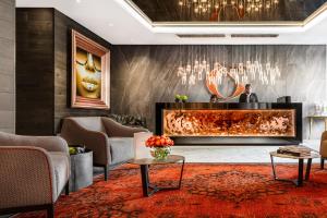 a lobby with a fireplace and couches at O' Two Hotel in Cape Town