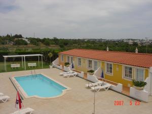 a house with a swimming pool and a building at SOLAR DOS AVÓS in Guia