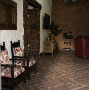 a living room with two chairs and a television at Llano San Ignacio in El Bosque