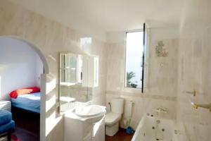 a bathroom with a sink and a toilet and a tub at SUPER ATICO PLAYA de MOJÁCAR - AMAZING PENTHOUSE at MOJÁCAR BEACH in Mojácar