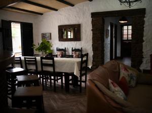 a living room with a table and chairs and a couch at Llano San Ignacio in El Bosque