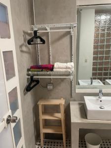 a bathroom with a sink and a mirror at The Emerald PR in San Juan