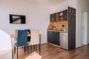 a kitchen with a table and chairs in a room at VILA PUPA with Lake view - Elešec in Ohrid