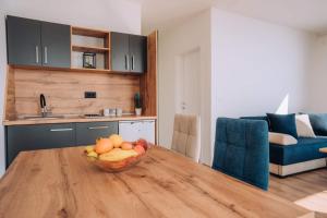 a bowl of fruit on a wooden table in a kitchen at VILA PUPA with Lake view - Elešec in Ohrid +24 photos
