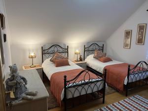 a bedroom with two beds and two tables with lamps at Pleasant Apartments in Bled