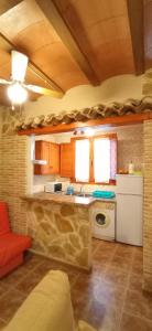 a kitchen with a sink and a stove top oven at Casa Camille.Villares Elche de la Sierra in Elche de la Sierra