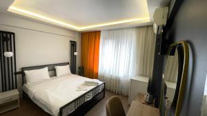 Postel nebo postele na pokoji v ubytování Ora Bella Hotel + 10 fotografií