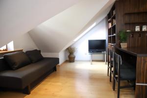 a living room with a couch and a tv at Lovely apartment in city Center of Jelenia Gora. in Jelenia Góra