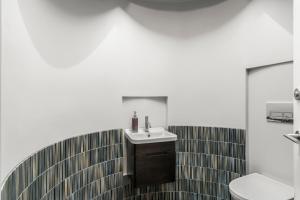 a bathroom with a sink and a toilet at A Stunning Stay - Queenstown Holiday Home in Queenstown +20 photos