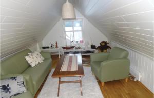 uma sala de estar com um sofá e duas cadeiras e uma mesa em Stunning Home In Flekkefjord With House Sea View em Flekkefjord