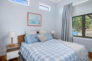 a bedroom with a bed and a window at Ekhaya - New Plymouth Holiday Home in New Plymouth