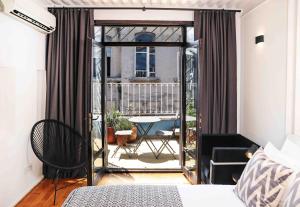 a bedroom with a bed and a balcony with a table at BLUE PERA HOUSE in Istanbul