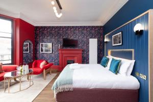 a bedroom with blue and red walls and a bed at 30 Castle Street Deluxe Apartments in Edinburgh