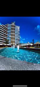 a large pool of blue water in front of a building at Garden Grandresidence in Basaksehir