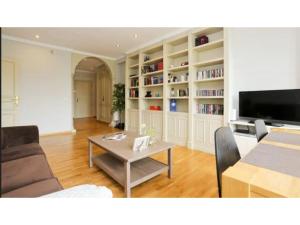 ein Wohnzimmer mit einem Tisch und einem TV in der Unterkunft Madrid Views Apartment in Madrid