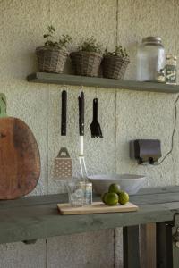 a counter with knives and utensils on a shelf at Duneden Belle Glamping in Randalstown