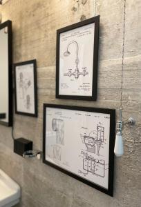 a framed drawing of a bathroom sink with pictures on a wall at Loft 56 in Porto SantʼElpidio +15 photos