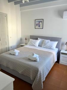 a bedroom with a large bed with towels on it at Patmos Garden in Skala