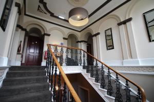 a stairway leading up to a large room at The Royal Hotel Elgin in Elgin