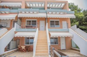 a house with a staircase in front of it at House Vraсhos-Loutsa in Vrachos