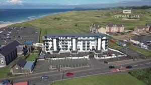 an aerial view of a building next to the ocean at Curran Gate Luxury Serviced Apartments, Portrush in Portrush